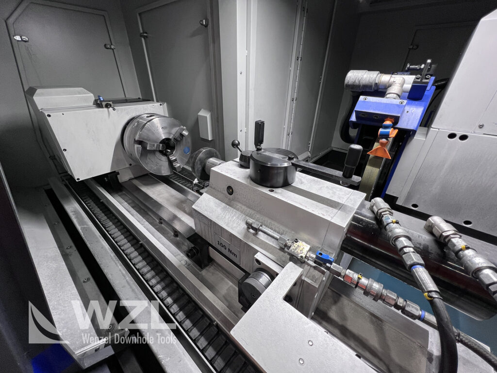 A view of the inside of the CU-600 CNC cylindrical grinder, with headstock, tailstock and large grinding wheel (for outside surfaces) visible.