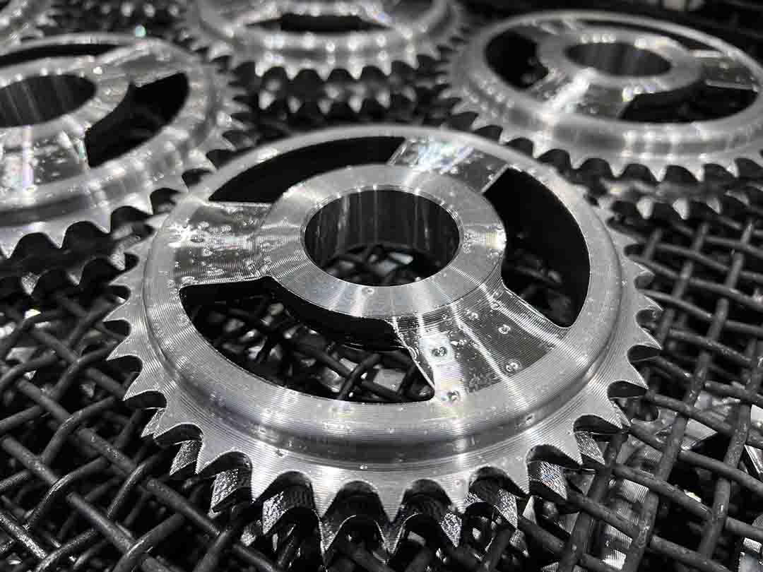 Freshly machined sprockets on a wire rack